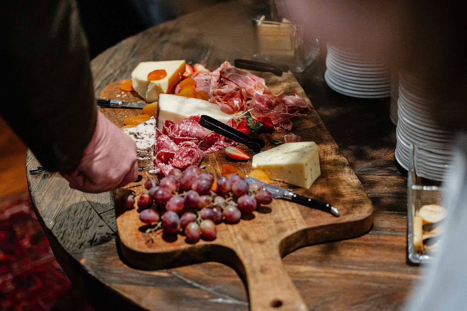 The Mill at Fine Creek Spring Wedding Photography in Powhatan 30 guests serving themselves from a charcuterie board