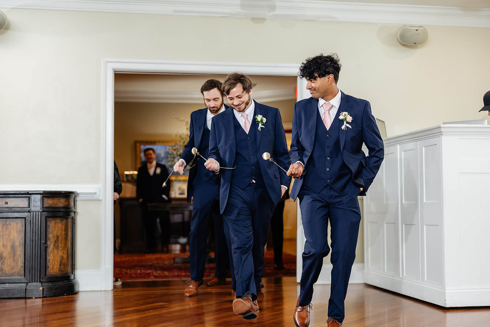 The Mill at Fine Creek Spring Wedding Photography in Powhatan 35 groomsmen walking into reception hall swinging pocket watches