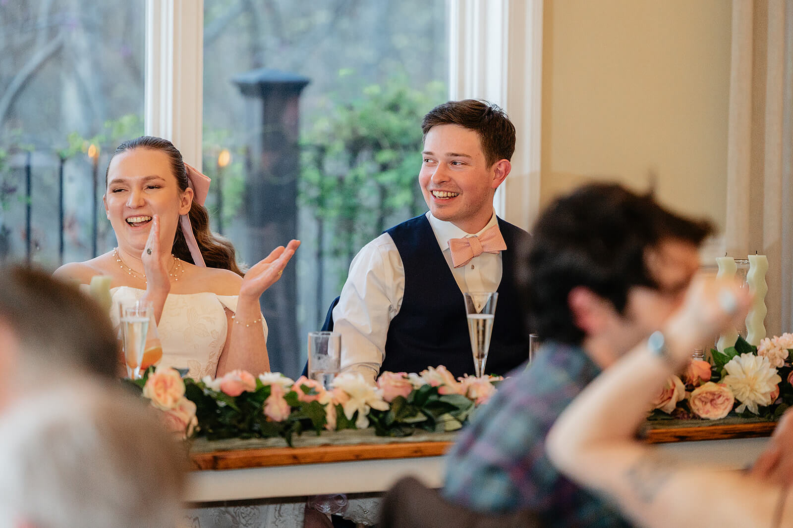 The Mill at Fine Creek Spring Wedding Photography in Powhatan 41 bride and groom sitting down clapping and laughing