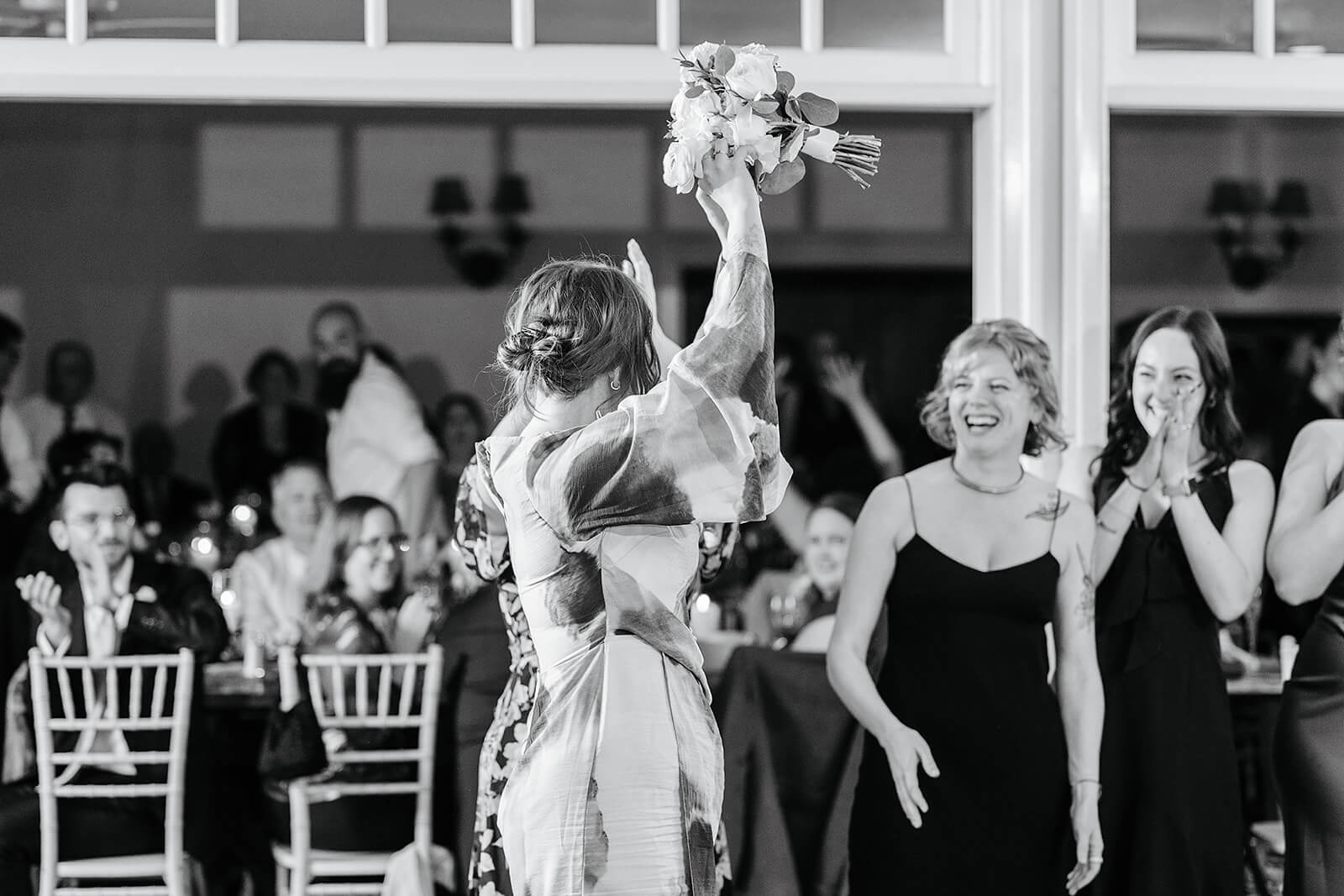 The Mill at Fine Creek Spring Wedding Photography in Powhatan 44 black and white photo of guests catching the bride's bouquet