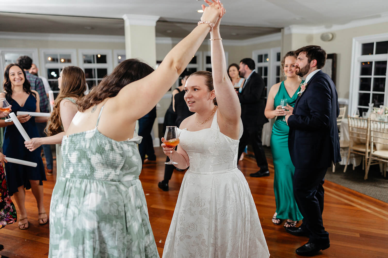 The Mill at Fine Creek Spring Wedding Photography in Powhatan 45 bride holding hands with a guest and dancing