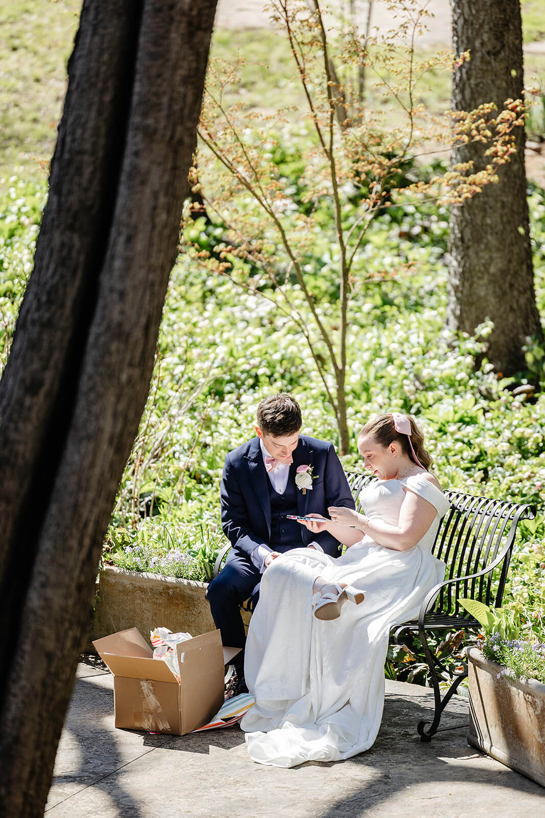 The Mill at Fine Creek Spring Wedding Photography in Powhatan 16 bride and groom sitting on a bench exchanging gifts