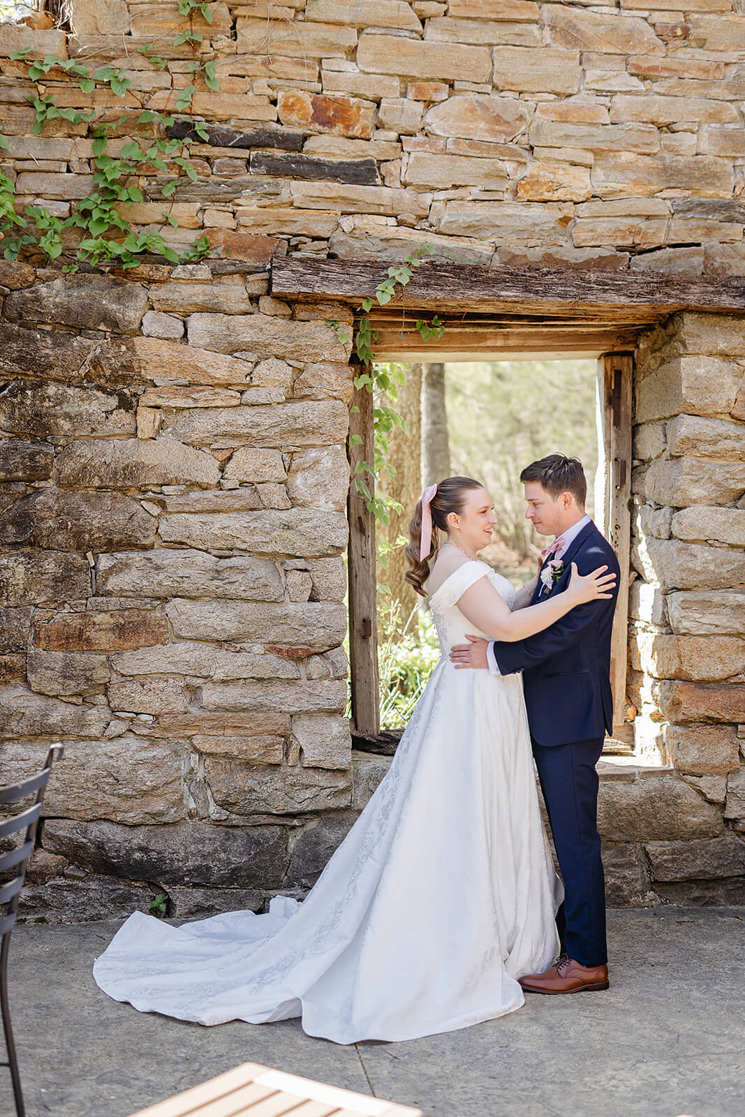 The Mill at Fine Creek Spring Wedding Photography in Powhatan 17 bride and groom in stone courtyard holding each other