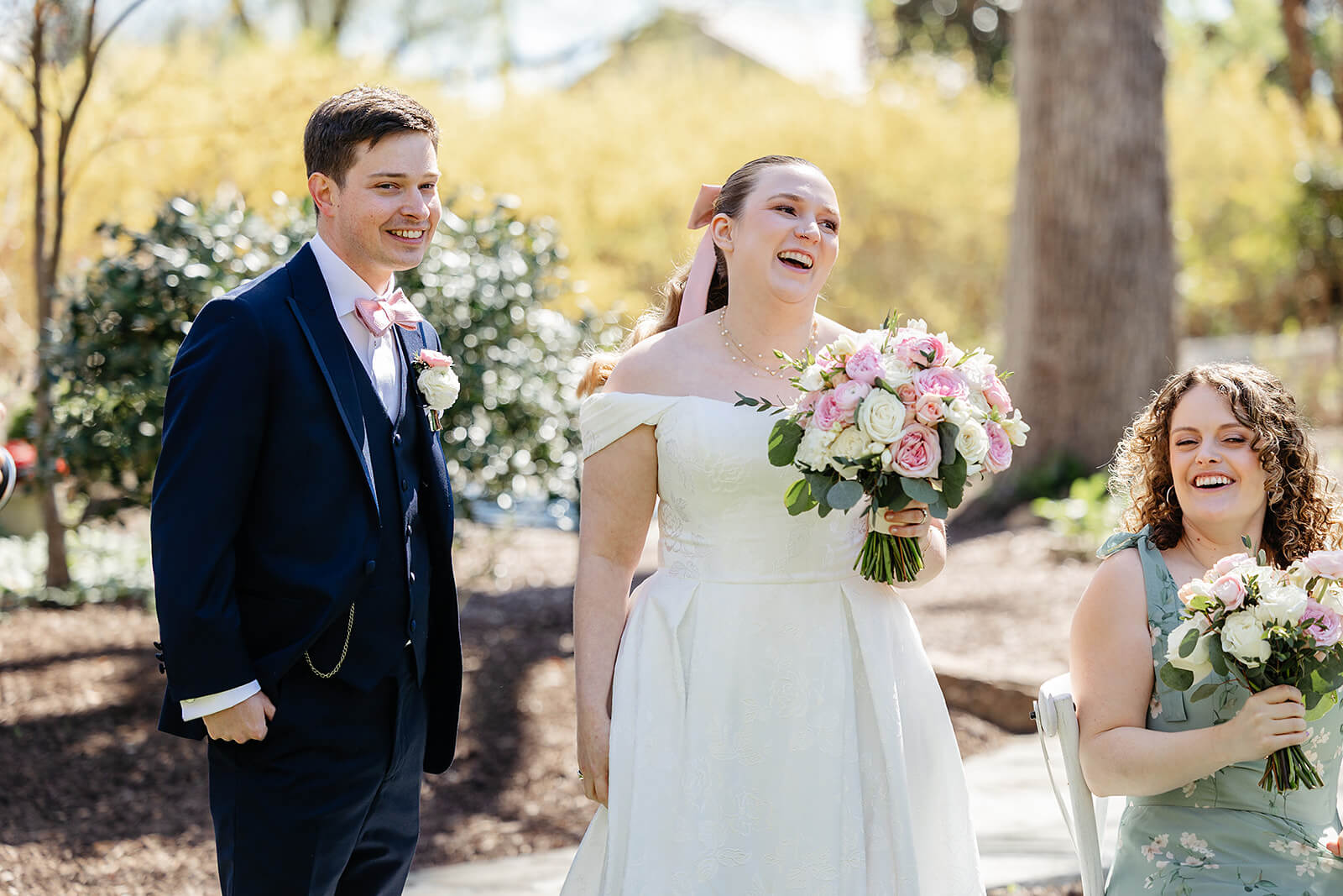 The Mill at Fine Creek Spring Wedding Photography in Powhatan 20 bride and groom outside with their wedding party, laughing