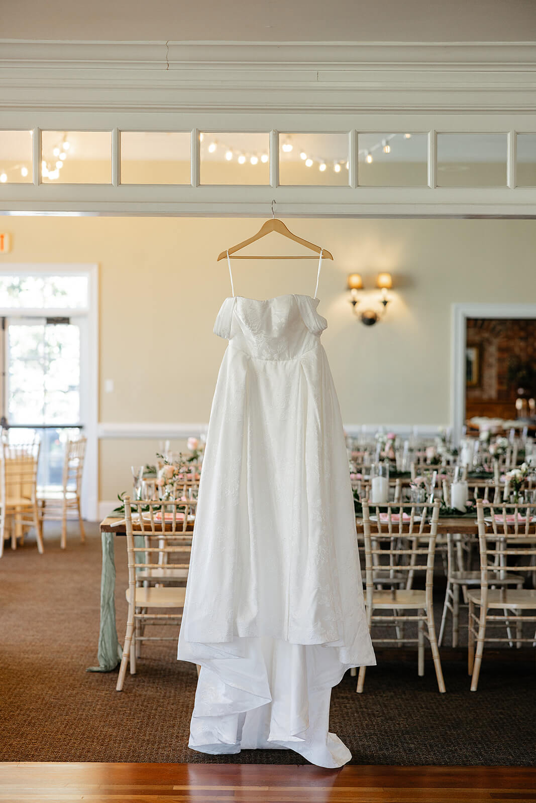 The Mill at Fine Creek Spring Wedding Photography in Powhatan 5 brides dress hanging in the reception area