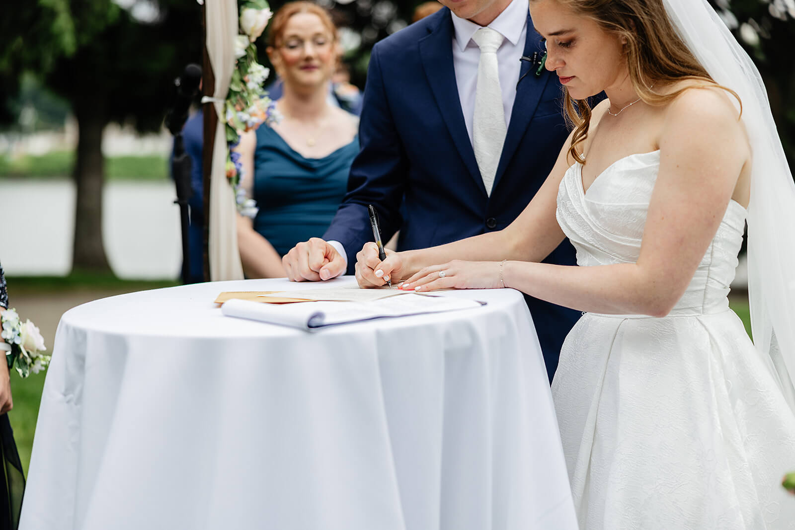 Allegheny RiverTrail Park Spring Wedding Photography 21 bride and groom signing their certificate during the ceremony