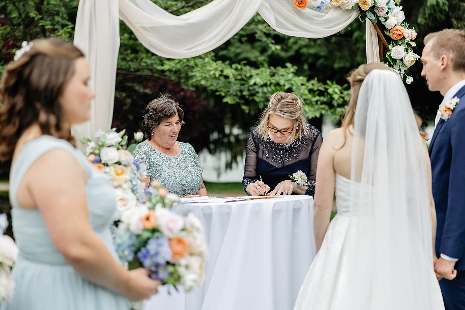 Allegheny RiverTrail Park Spring Wedding Photography 22 bride and groom watching guests sign their certificate