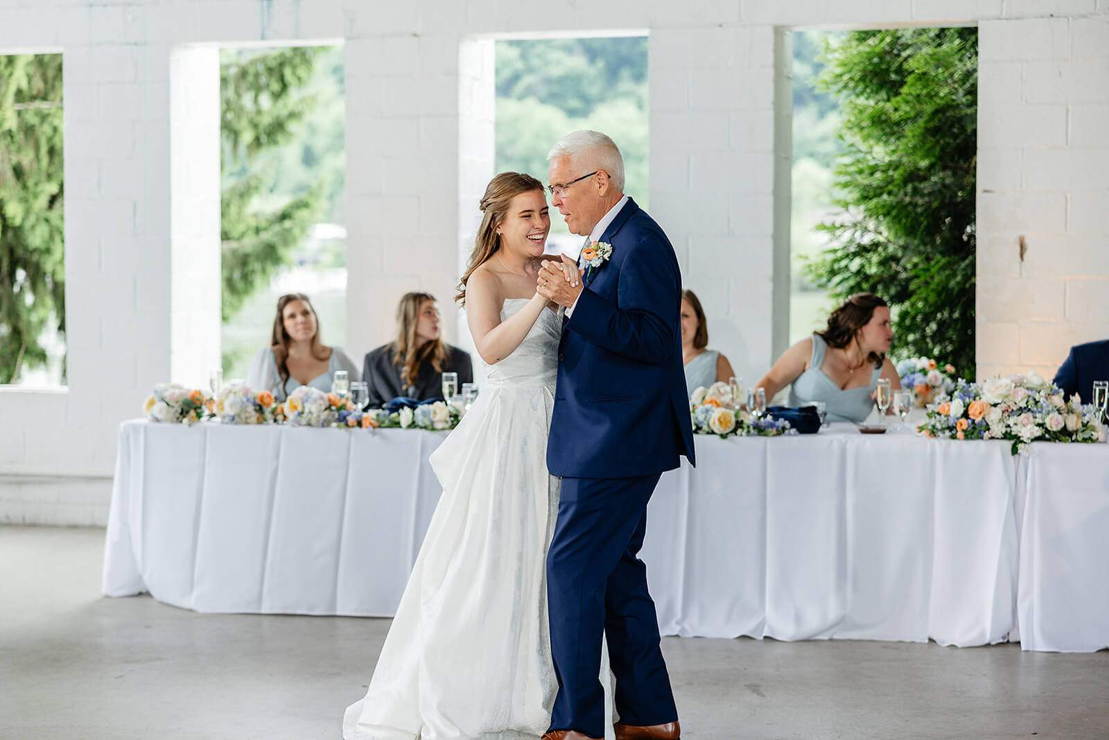 Allegheny RiverTrail Park Spring Wedding Photography 34 bride dancing with father, she is smiling and the wedding party is watching and smiling