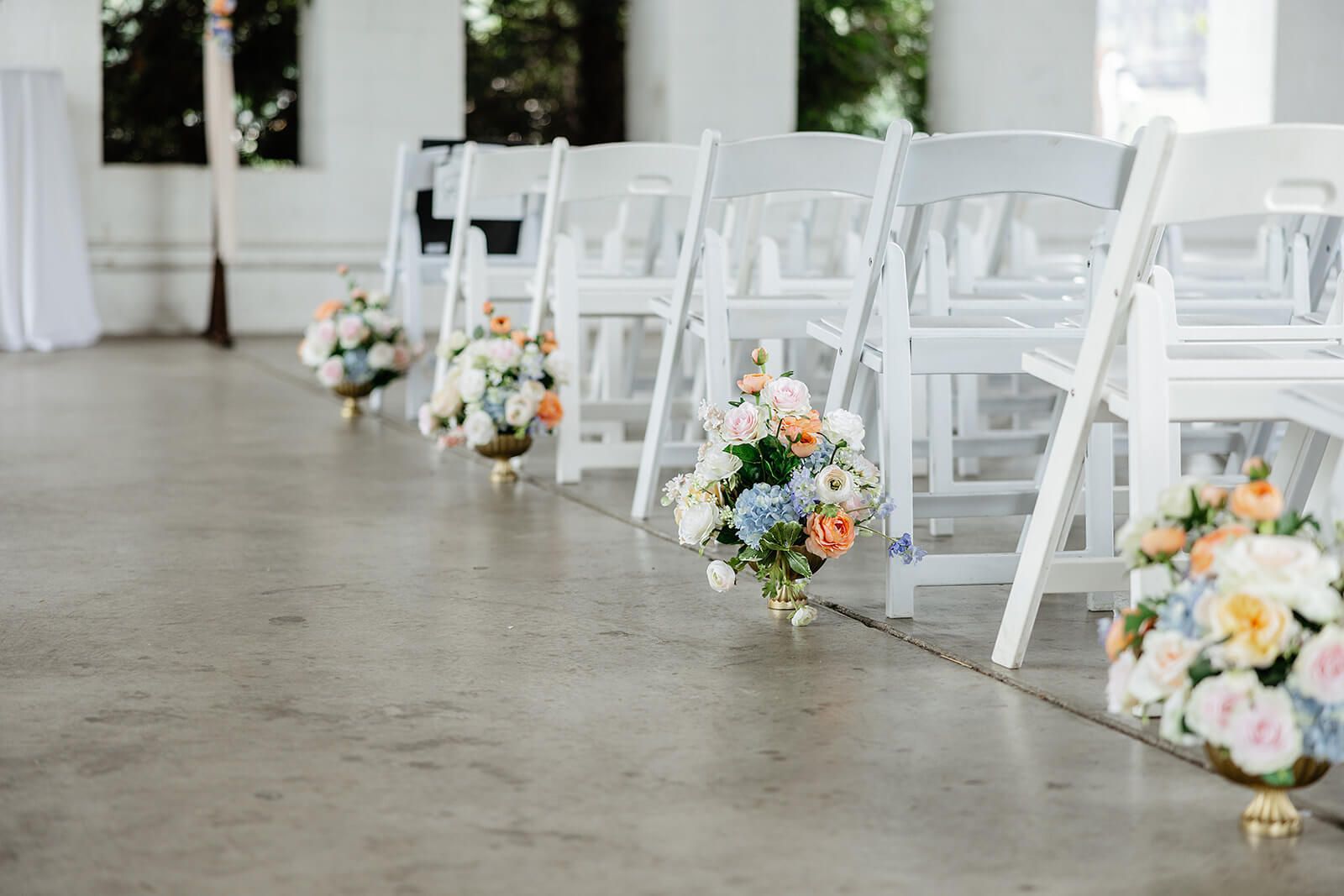 Allegheny RiverTrail Park Spring Wedding Photography 14 detail photo of floral arrangements on the ground by the ceremony chairs