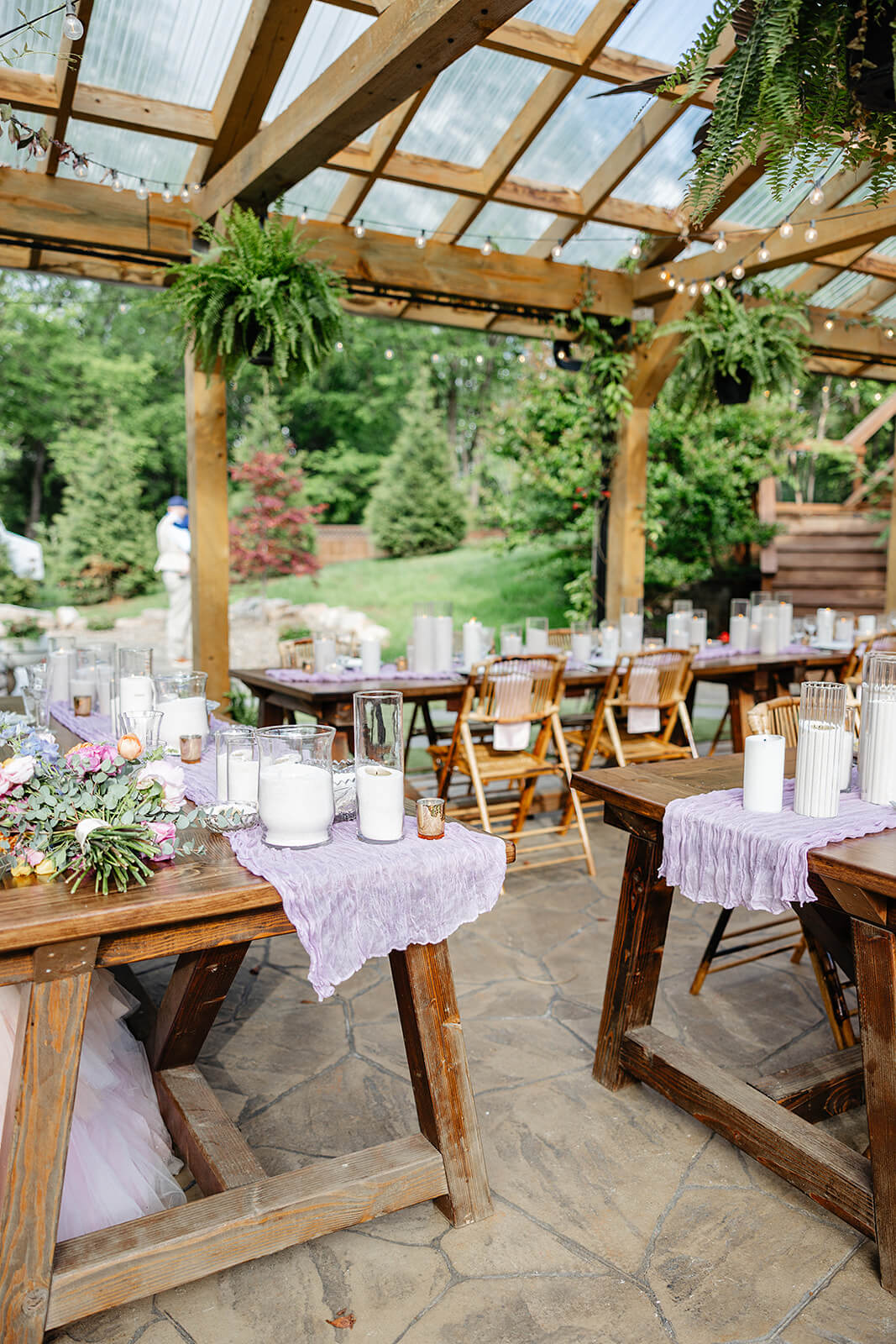 Vaughan Greenhouse Spring Wedding Photography 20 reception area with tables covered in candles, florals, and lavender linens
