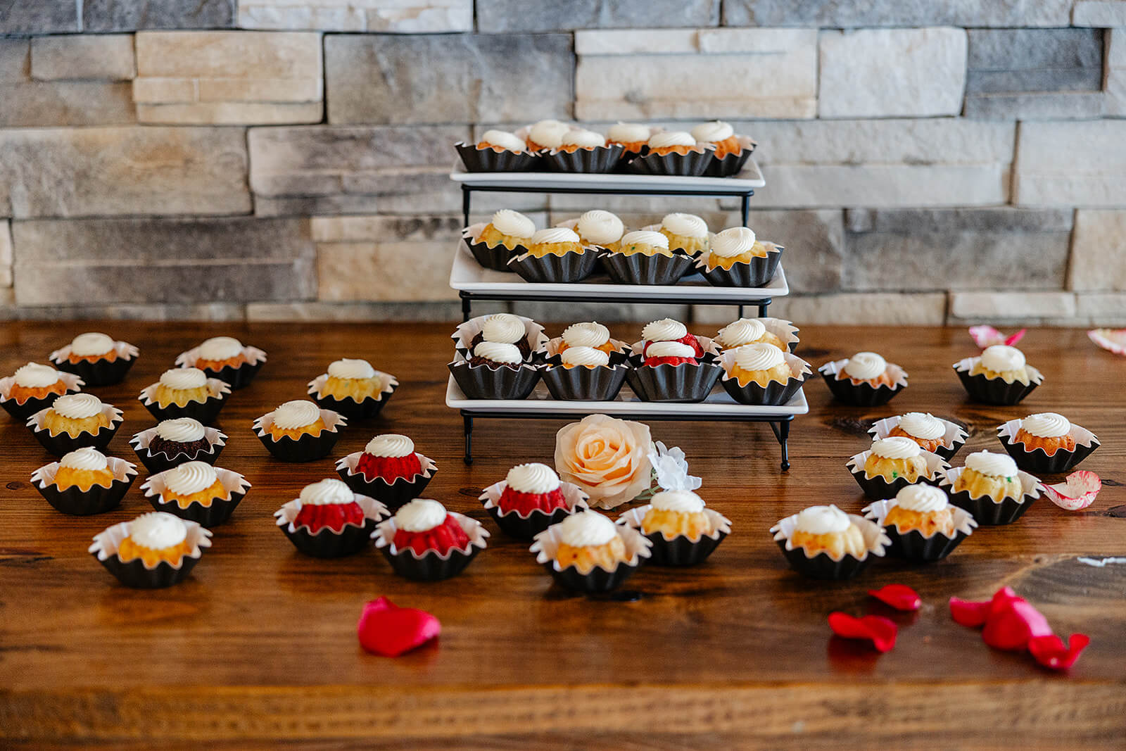 Vaughan Greenhouse Spring Wedding Photography 22 dessert table with cupcake scattered around and on a cake pedestal