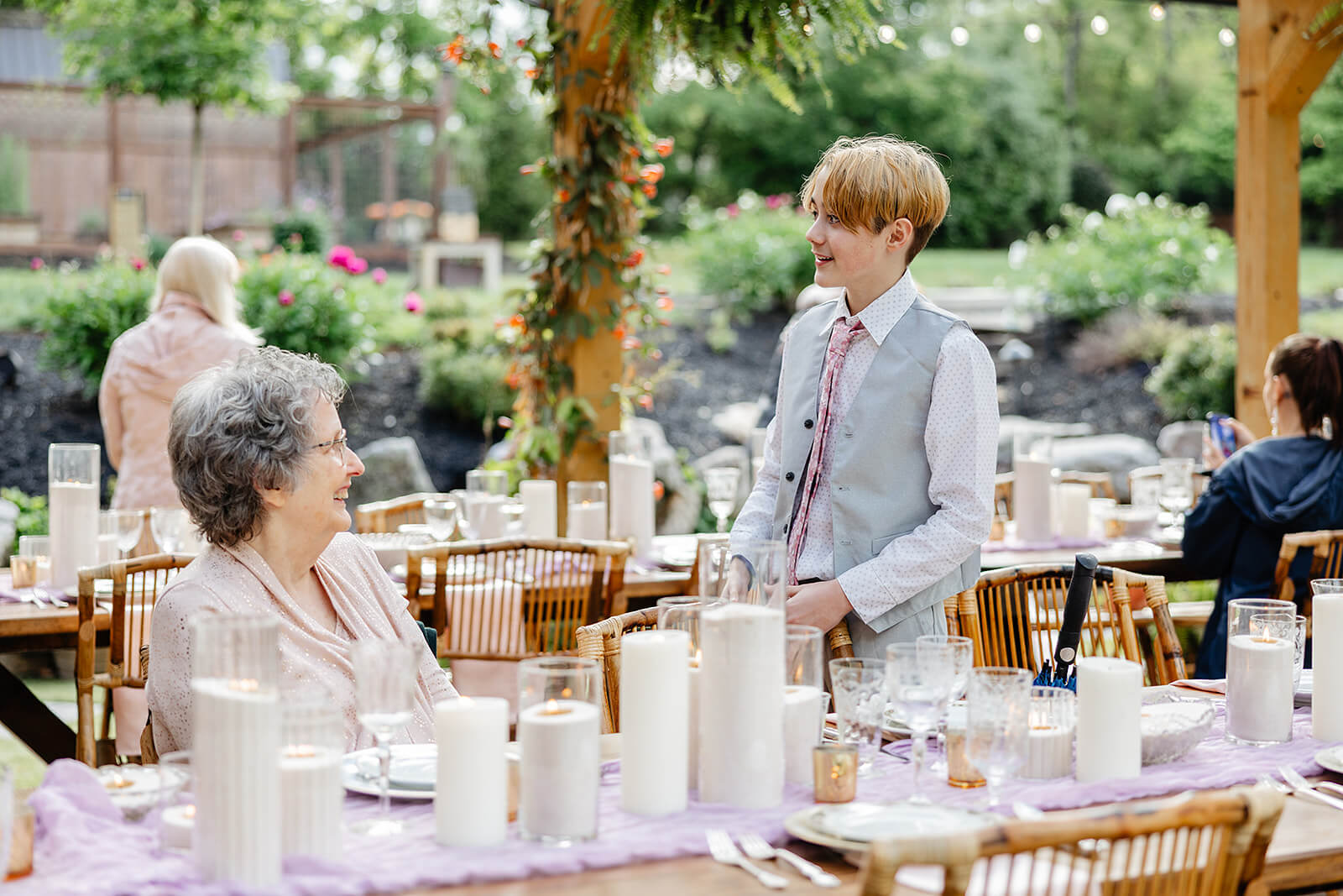 Vaughan Greenhouse Spring Wedding Photography 24 guests sitting at tables talking and smiling
