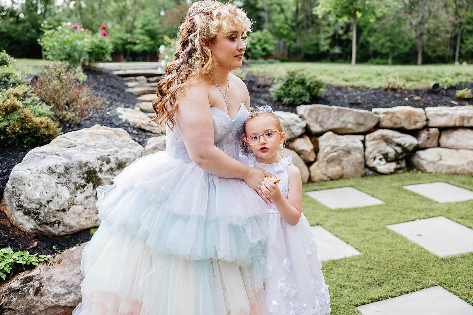 Vaughan Greenhouse Spring Wedding Photography 26 bride hugging flower girl on the lawn
