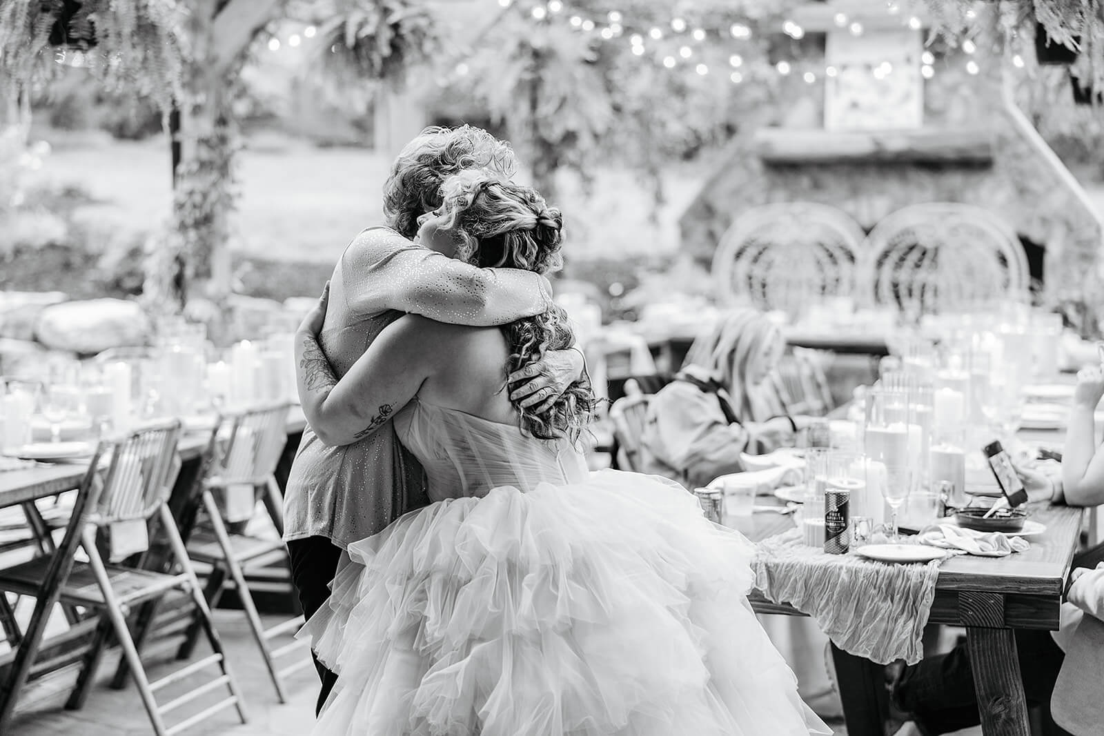 Vaughan Greenhouse Spring Wedding Photography 27 black and white photo of bride hugging a guest