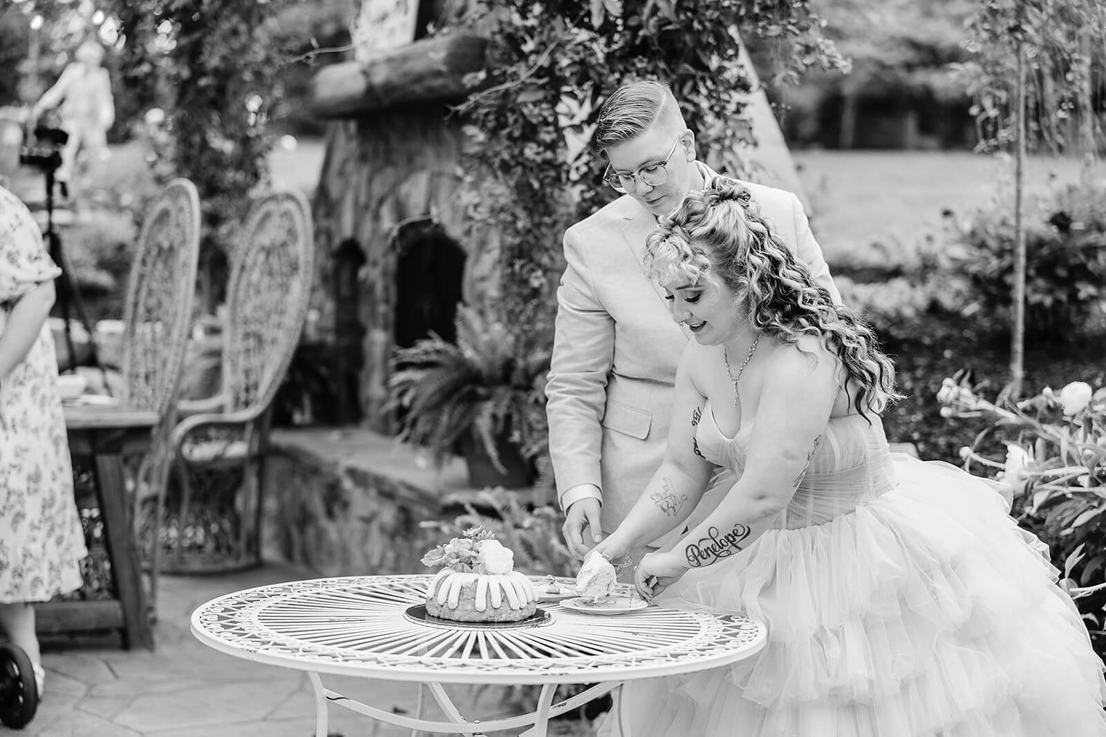 Vaughan Greenhouse Spring Wedding Photography 31 black an white photo of bride and groom cutting and serving their cake