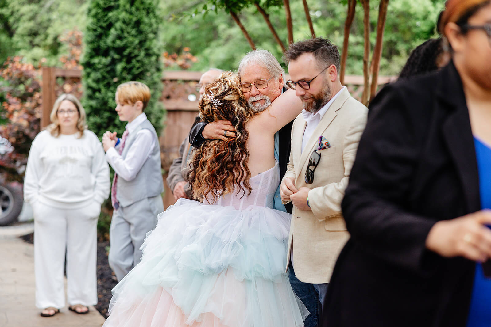 Vaughan Greenhouse Spring Wedding Photography 40 bride hugging a guest good by