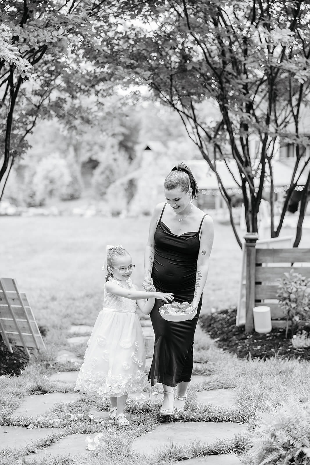 Vaughan Greenhouse Spring Wedding Photography 7 black and white photo of flower girl and officiant walking down the aisle