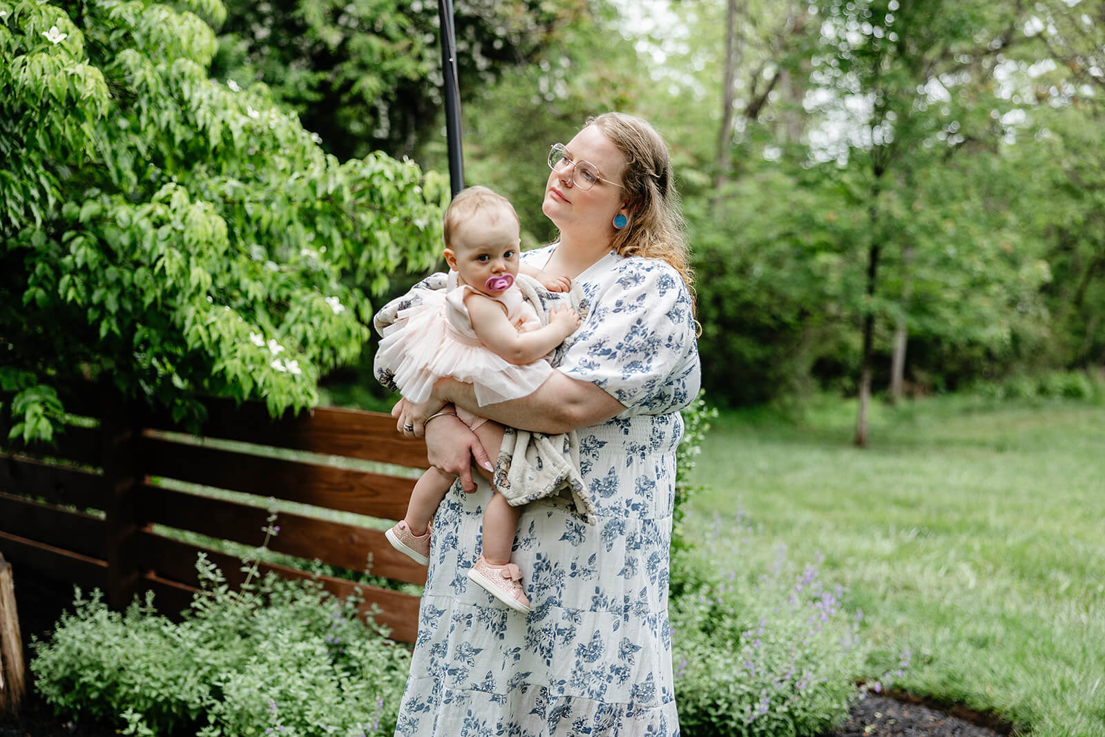 Vaughan Greenhouse Spring Wedding Photography 11 guests standing and holding a baby while watching the ceremony