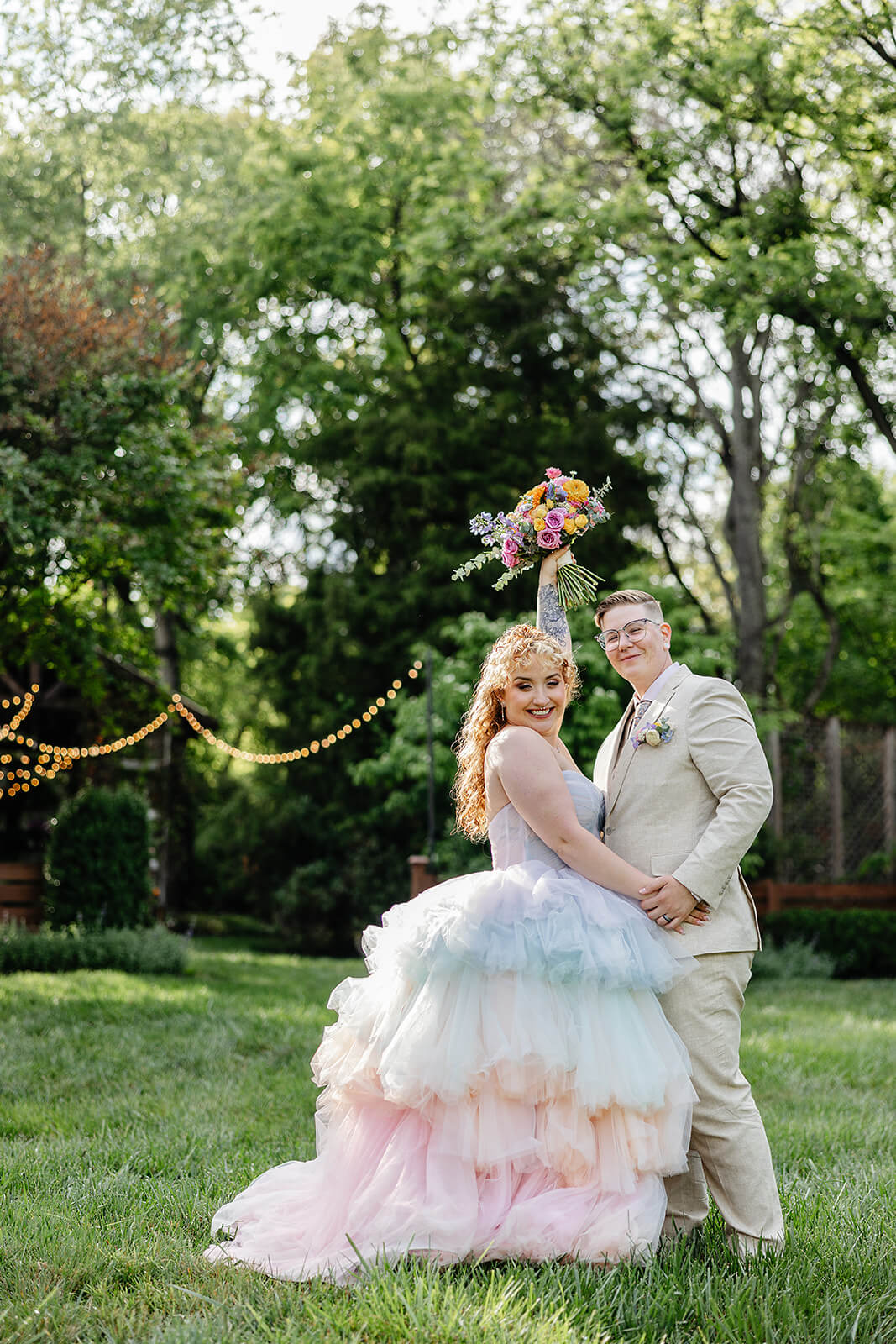 Vaughan Greenhouse Spring Wedding Photography 14 bride and groom outside, holding hands and raising the brides bouquet in the air