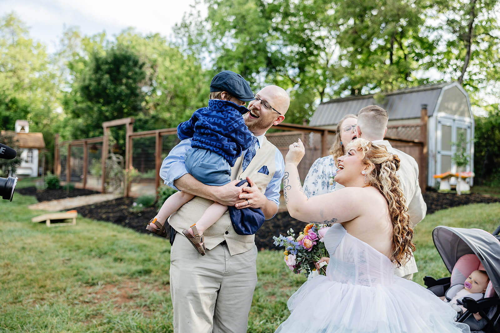 Vaughan Greenhouse Spring Wedding Photography 17 bride saying hello to guests and baby