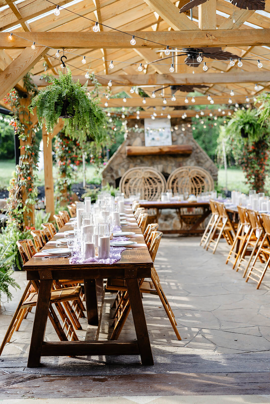 Vaughan Greenhouse Spring Wedding Photography 18 reception area with long wood tables, large ferns hanging from the ceiling and string lights