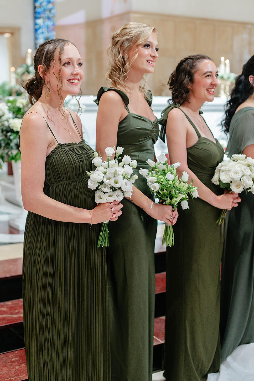 Matt + Adriana's May Wedding Photography 14 three bridesmaids in dark green dresses standing at the front of the church