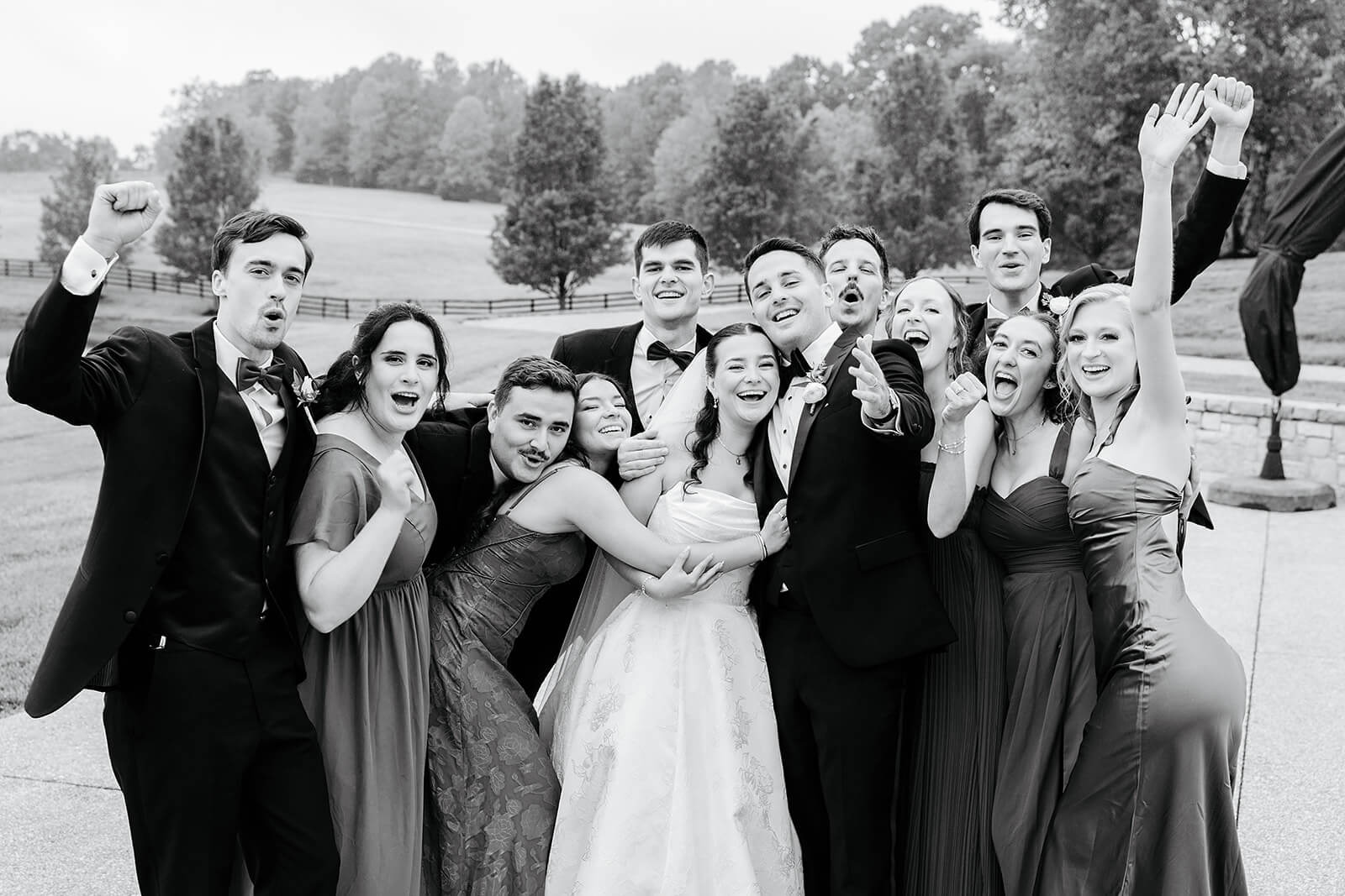 Matt + Adriana's May Wedding Photography 16 black and white photo of couple and wedding party grouped together and cheering outside