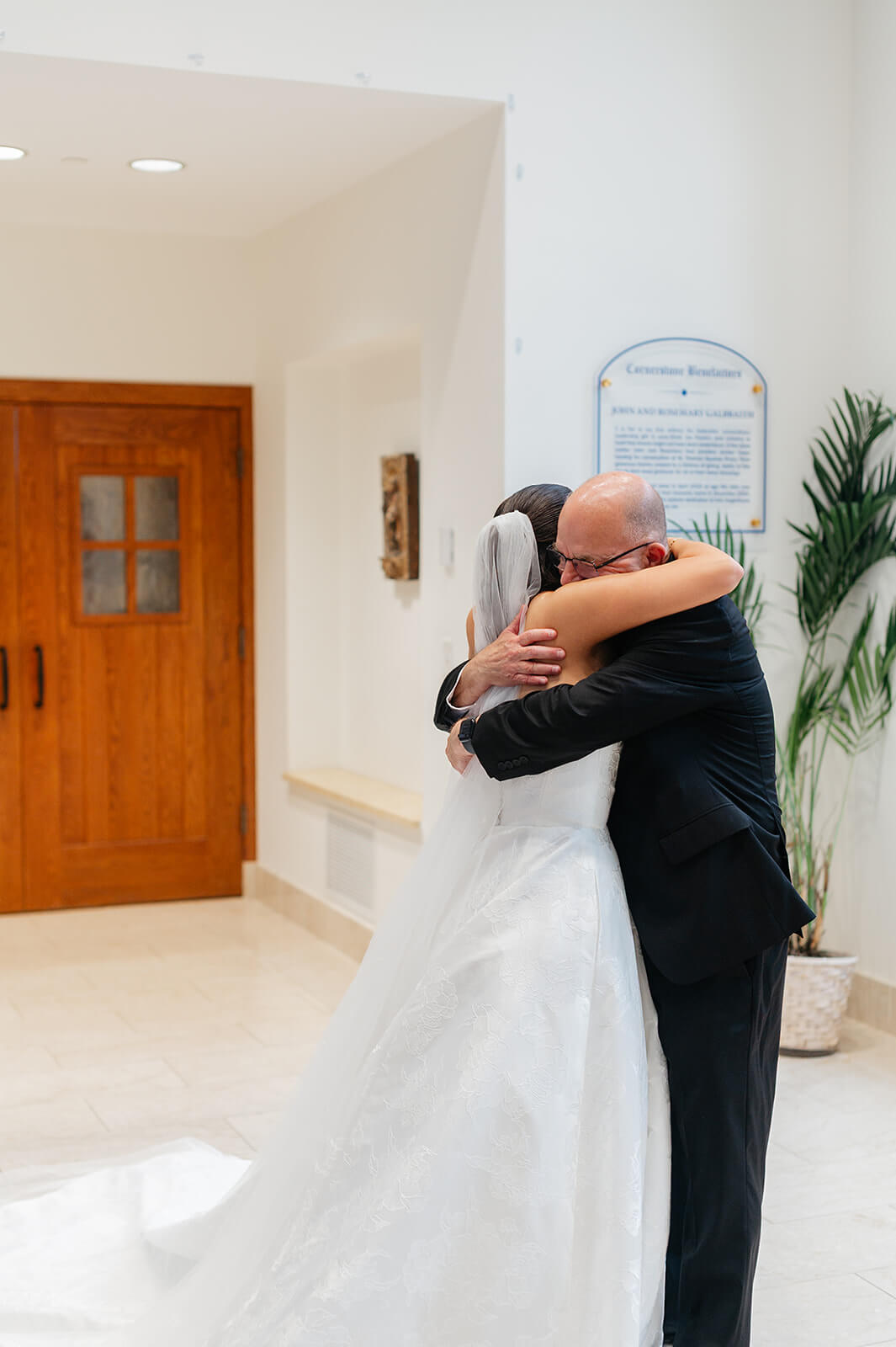 Matt + Adriana's May Wedding Photography 3 bride hugging her father in the lobby of a church