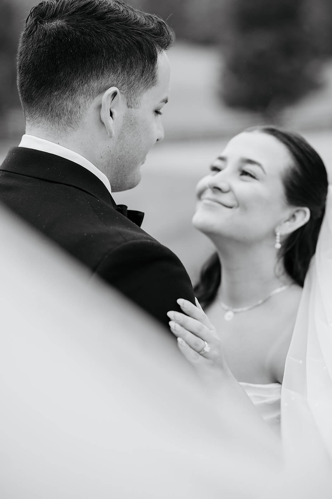 Matt + Adriana's May Wedding Photography 23 black and white photo of bride smiling up at groom, her veil is held up in the foreground
