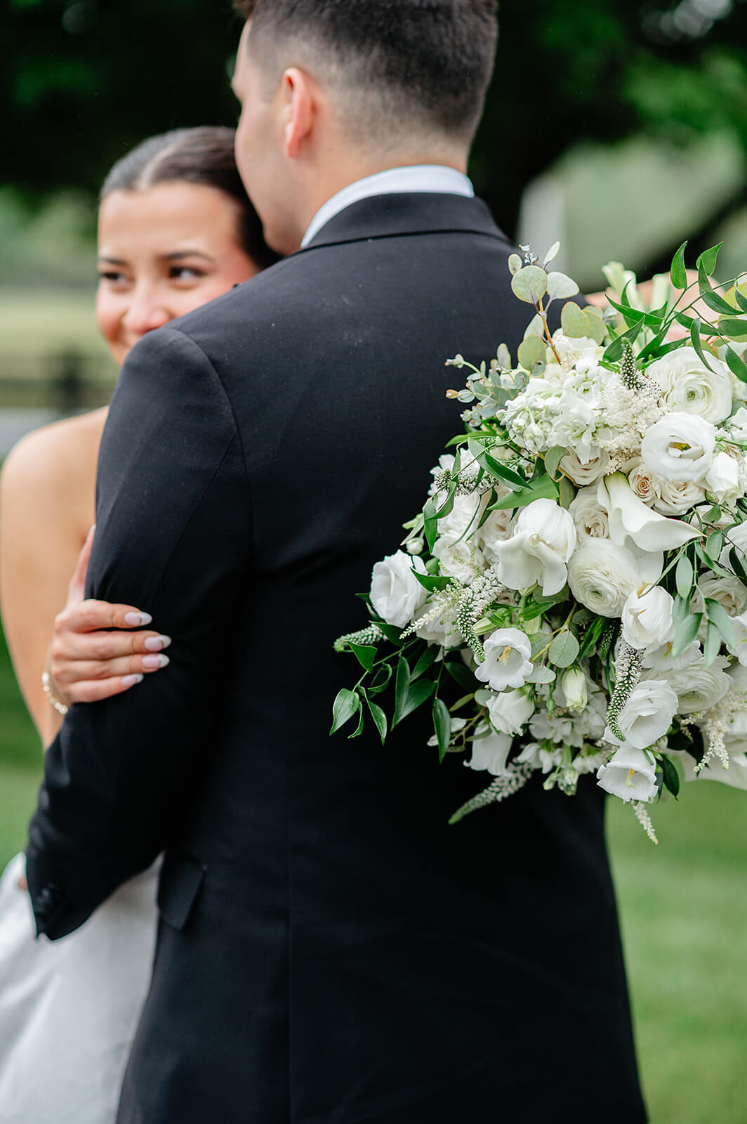 Matt + Adriana's May Wedding Photography 30 bride and groom hugging each other loosely, the bride is holding her white bouquet behind the groom's back