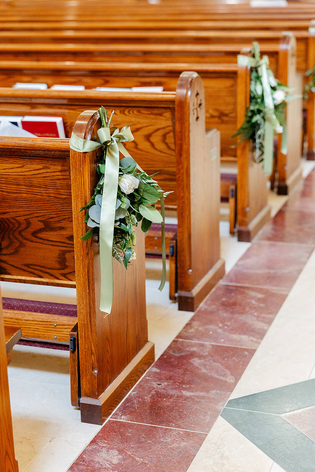 Matt + Adriana's May Wedding Photography 5 detail photo of white and green floral arrangements hanging from the pews