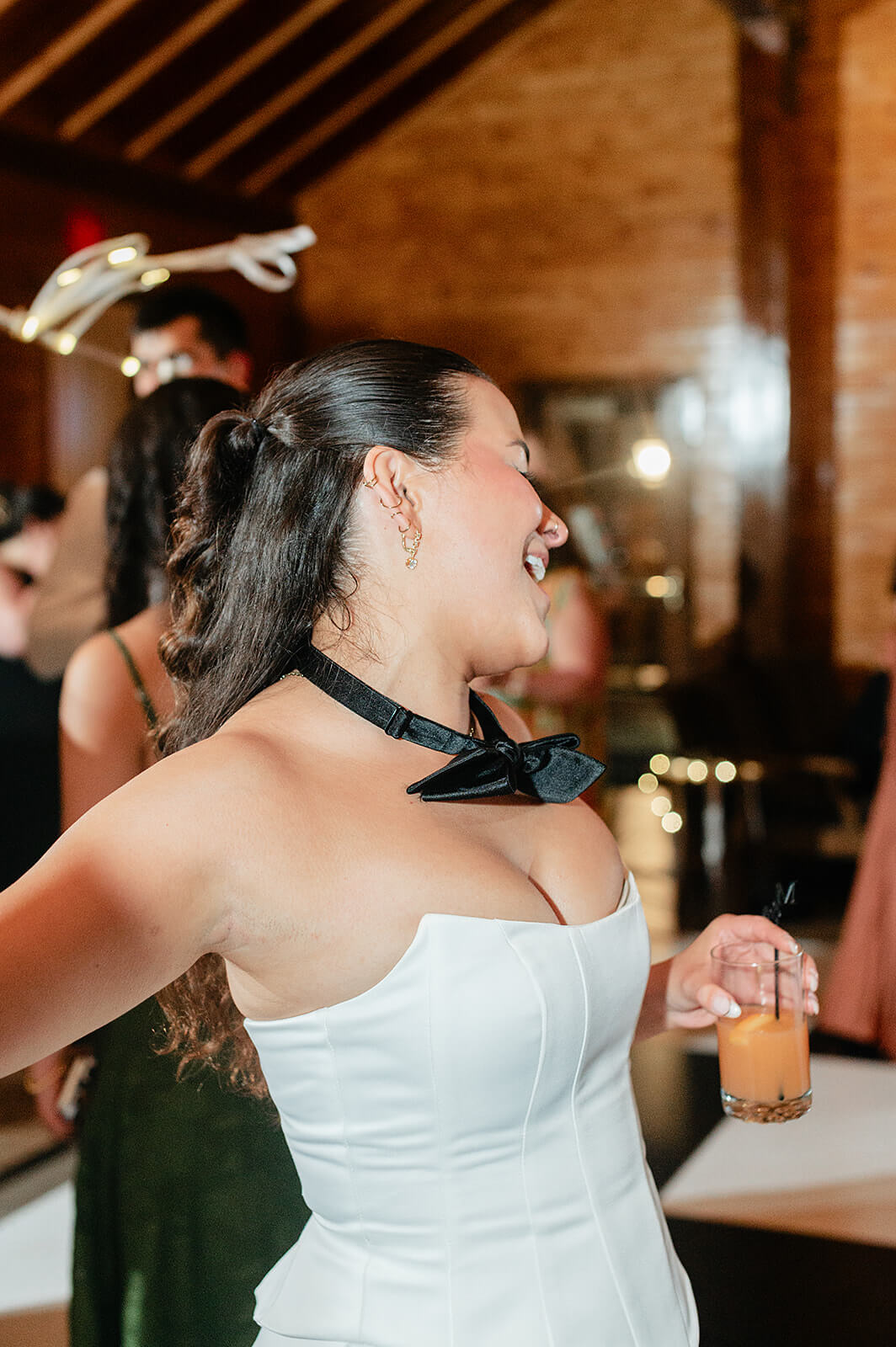 Matt + Adriana's May Wedding Photography 40 bride holding drink and wearing bowtie dancing