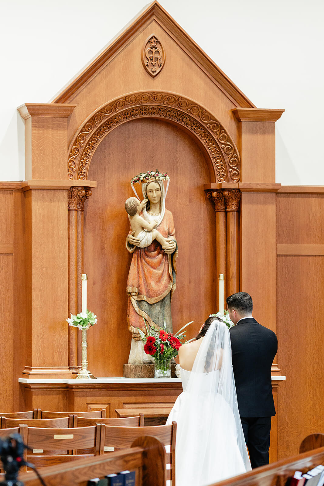 Matt + Adriana's May Wedding Photography 10 bride leaning her head on groom as they stand in front of statue of mary