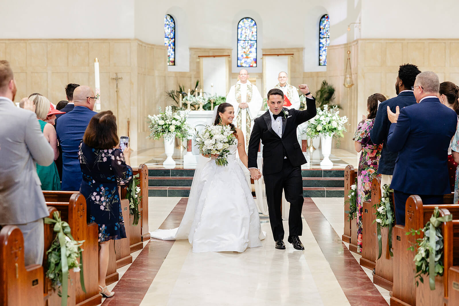 Matt + Adriana's May Wedding Photography 11 bride and groom cheering and holding hands as they walk down the aisle