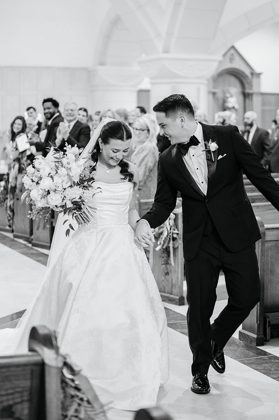 Matt + Adriana's May Wedding Photography 12 black and white photo of bride and groom holding hands and walking down the aisle
