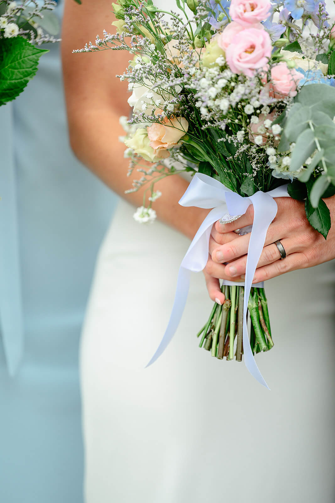 Family Farm Spring Wedding Photography 22 detail photo of bride and groom's hand holding bride's bouquet