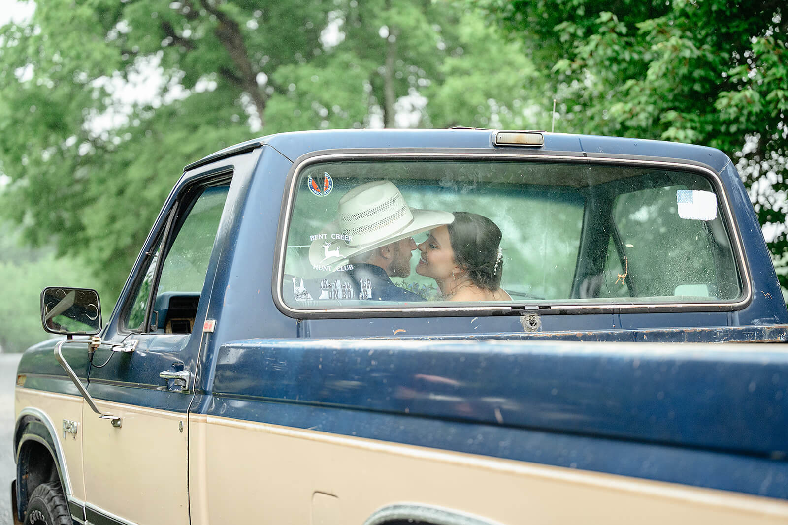 Family Farm Spring Wedding Photography 29 bride and groom kissing in the cab of an old for truck