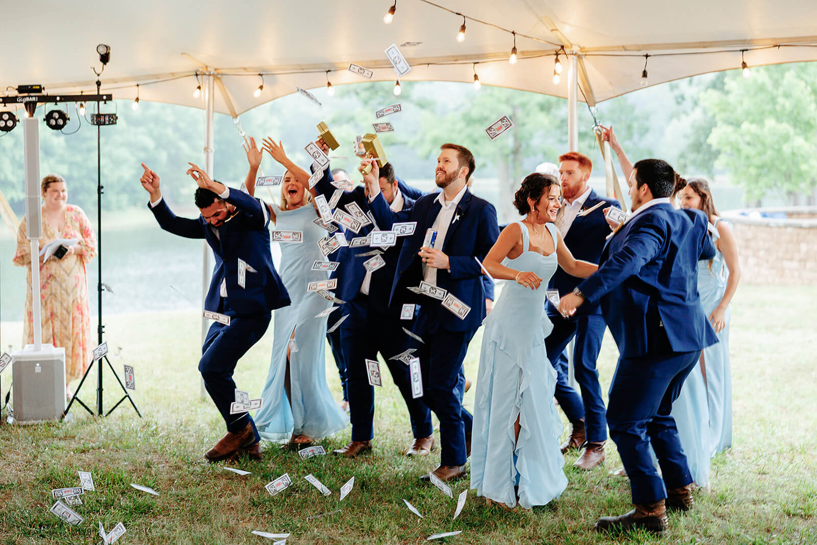 Family Farm Spring Wedding Photography 37 wedding party entering the reception tent and throwing fake money