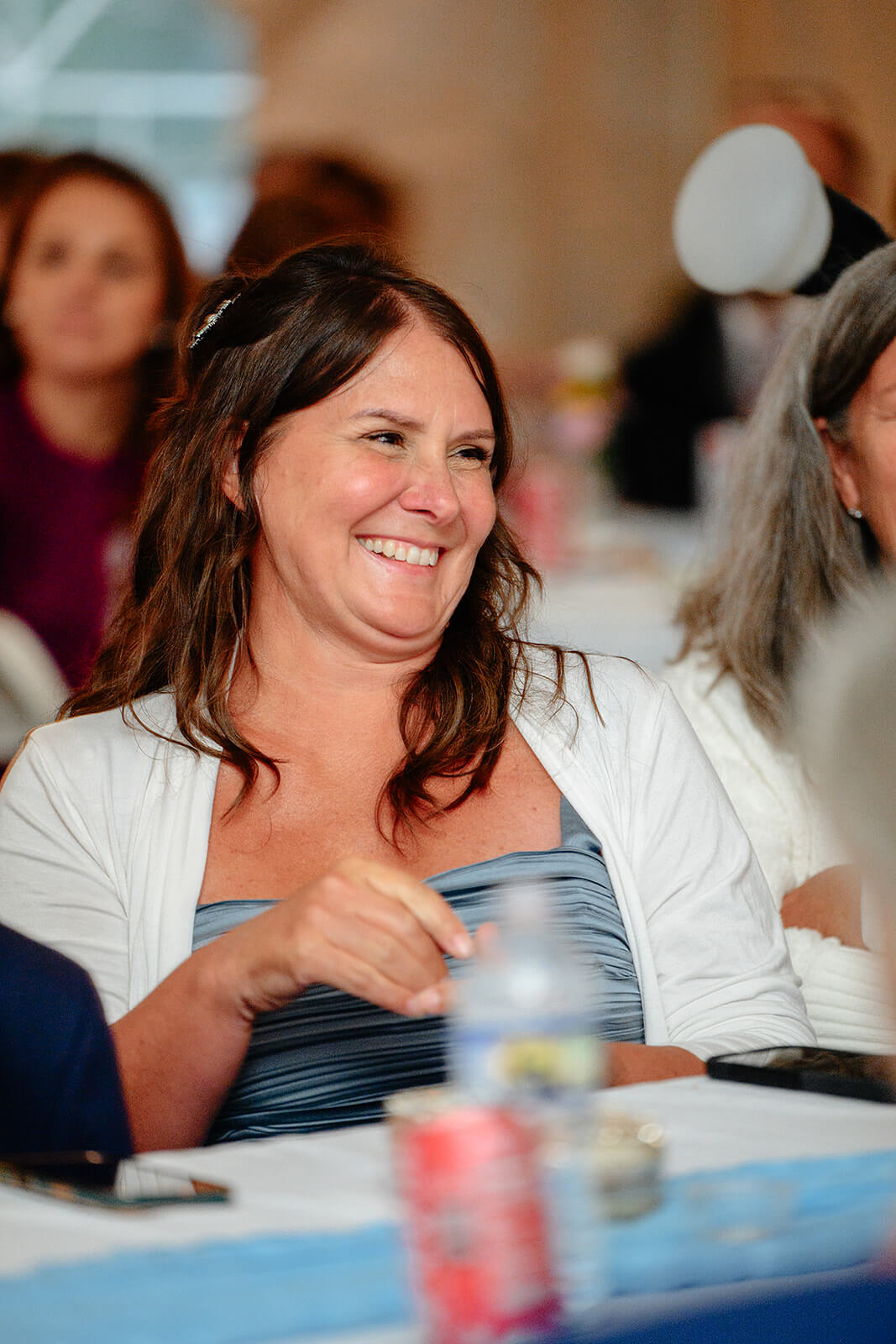 Family Farm Spring Wedding Photography 40 guest at table laughing at speech