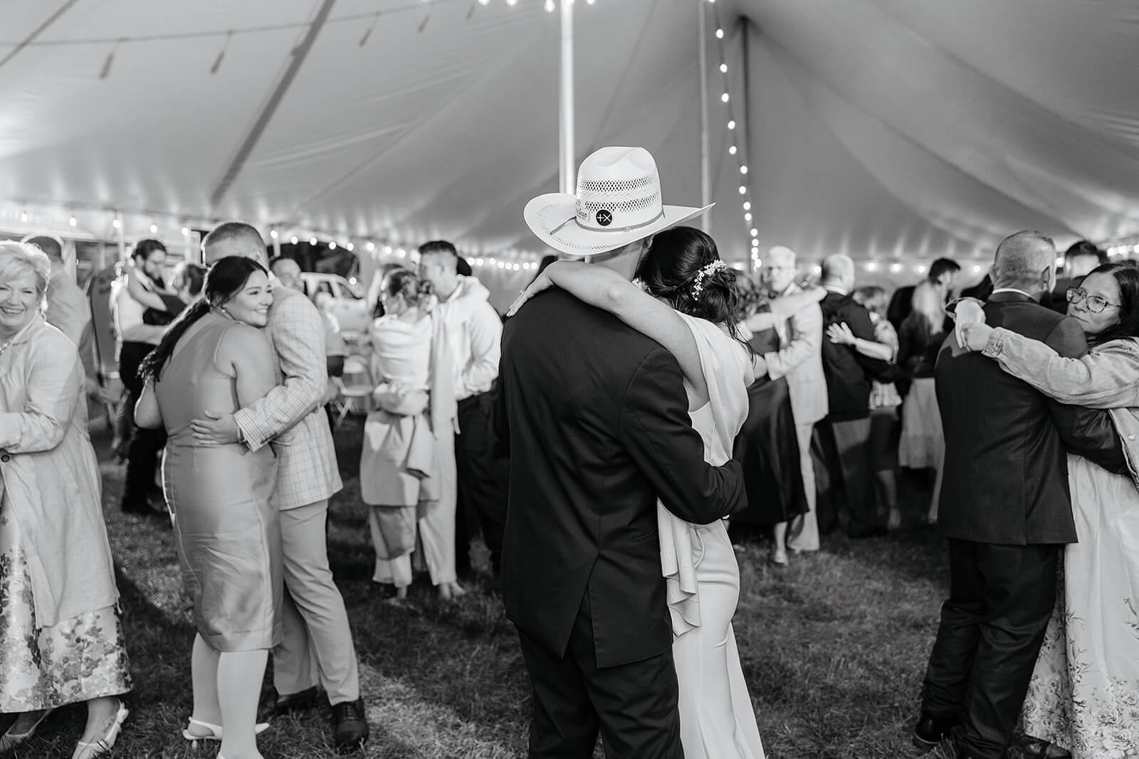 Family Farm Spring Wedding Photography 44 black and white photo of bride and groom dancing with lots of other couples dancing around them