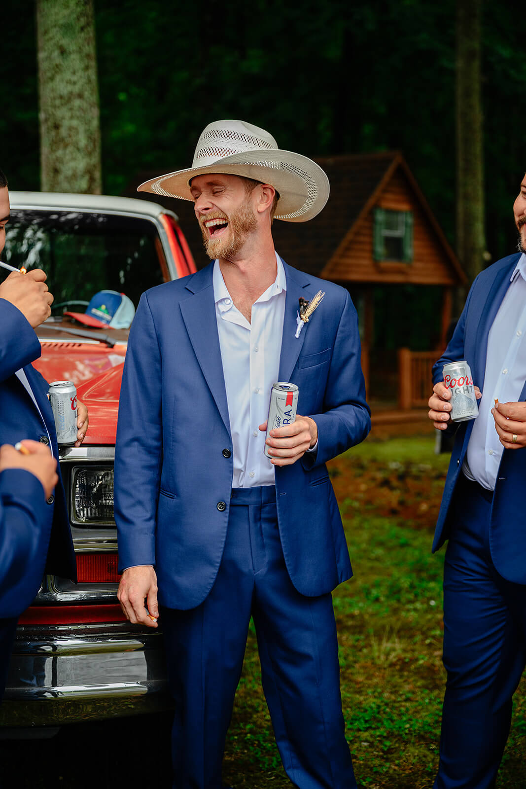 Family Farm Spring Wedding Photography 7 groom holding a beer and laughing with his groomsmen