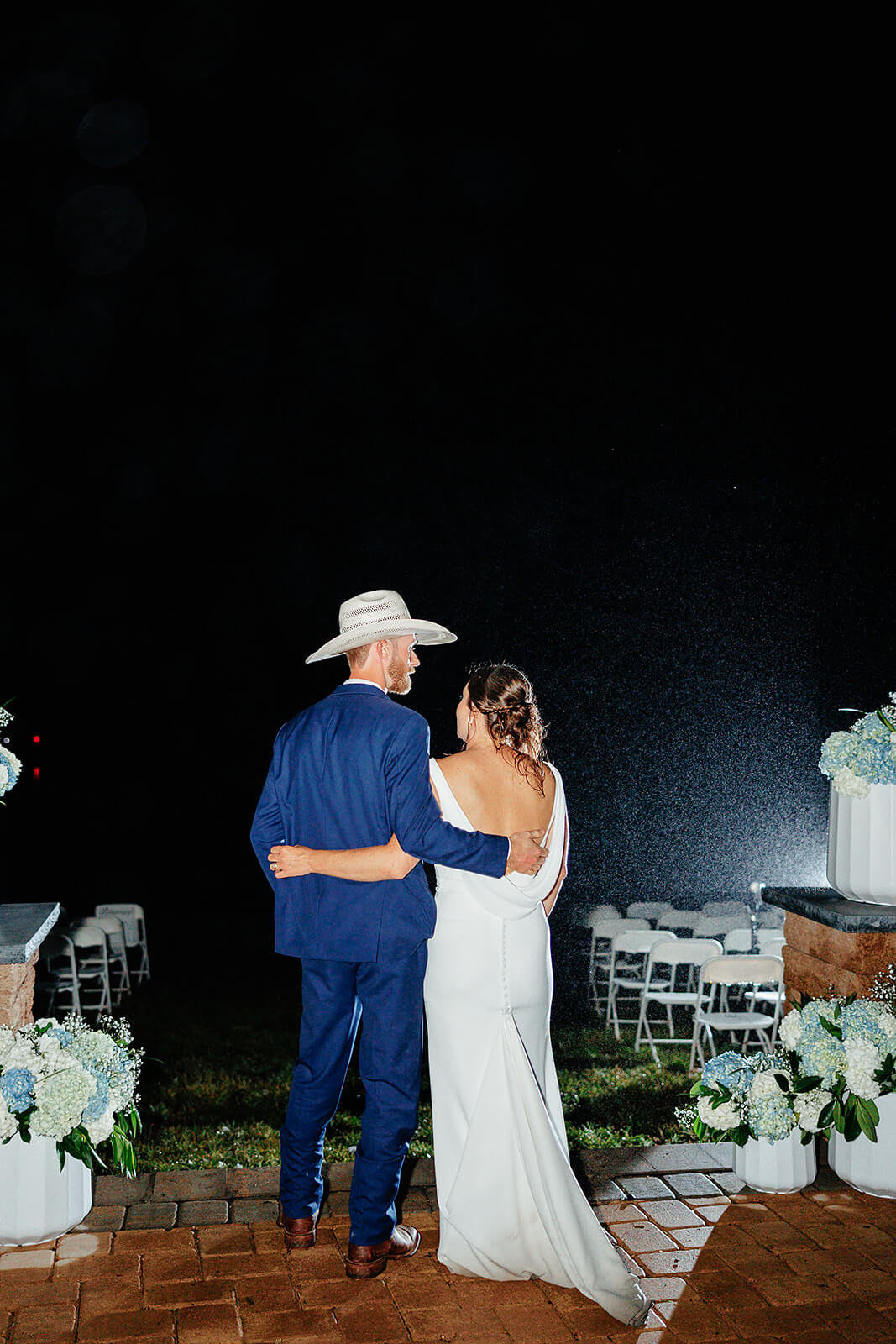 Family Farm Spring Wedding Photography 47 bride and groom hugging each other from the side in the rain