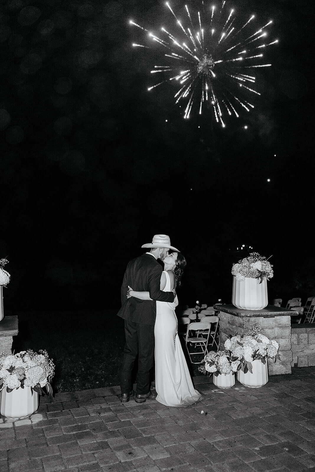 Family Farm Spring Wedding Photography 48 black and white photo of ride and groom kissing under fireworks