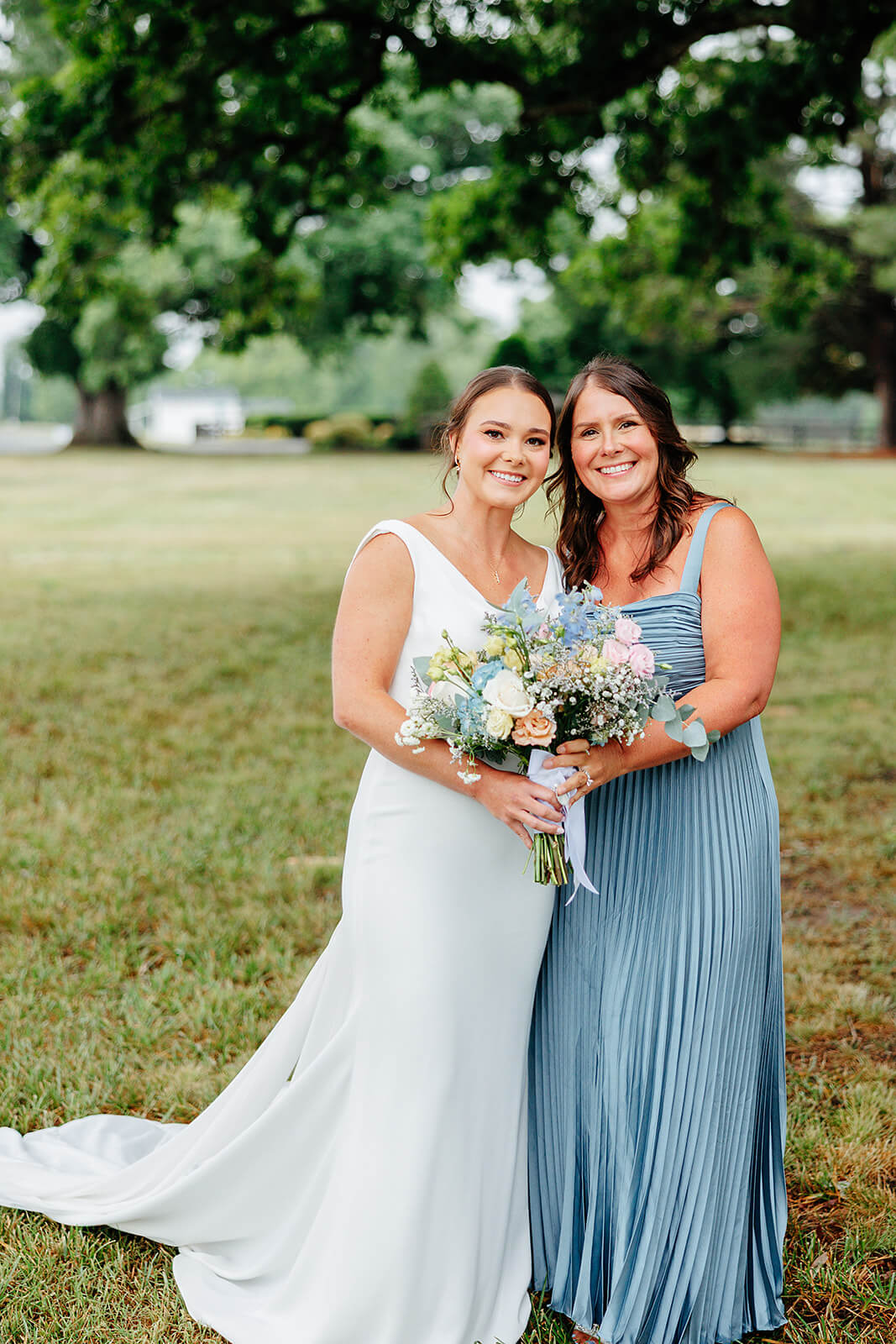 Family Farm Spring Wedding Photography 10 bride and bridesmaid holding a bouquet together