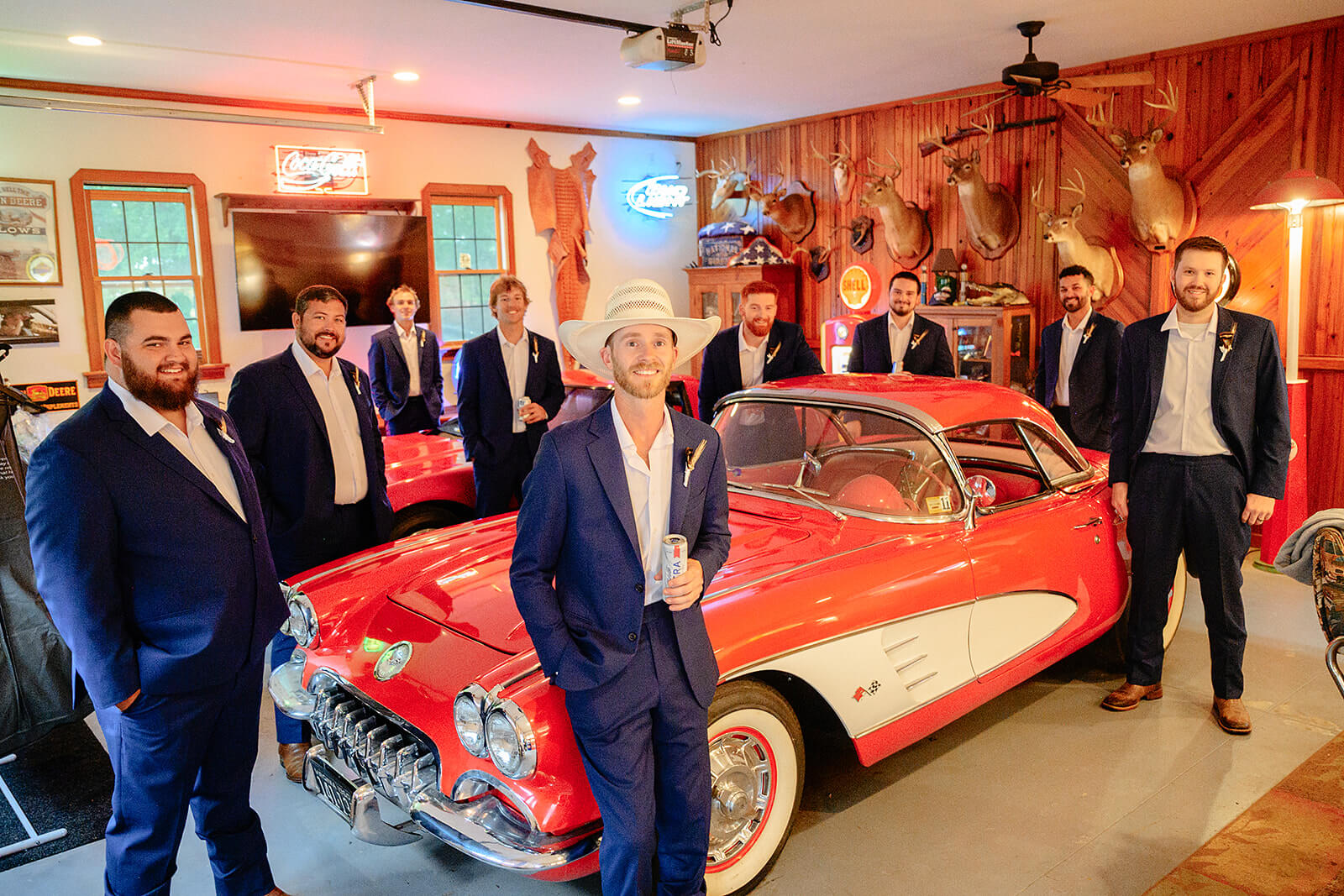 Family Farm Spring Wedding Photography 13 groom and groomsmen standing next to an antique, red and white sports car
