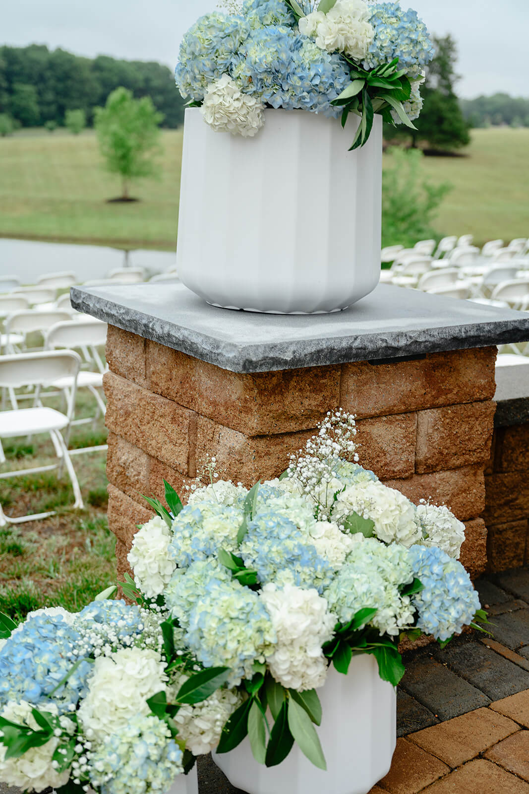 Family Farm Spring Wedding Photography 15 floral arrangements of blue and white hydrangeas in large white pots