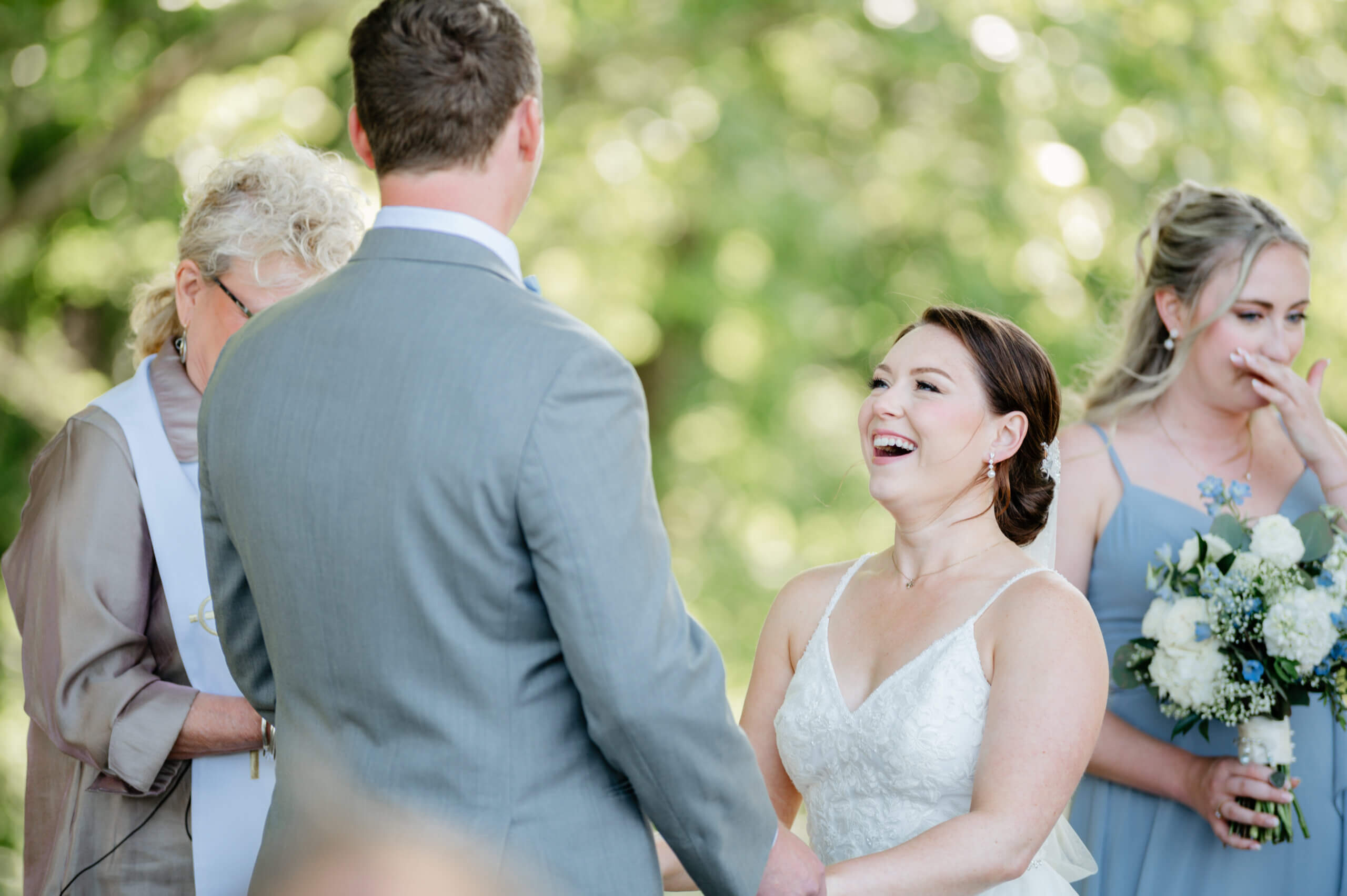 Malden Hill Spring Wedding Photography 17 bride and groom holding hands in front of the alter and bride is laughing