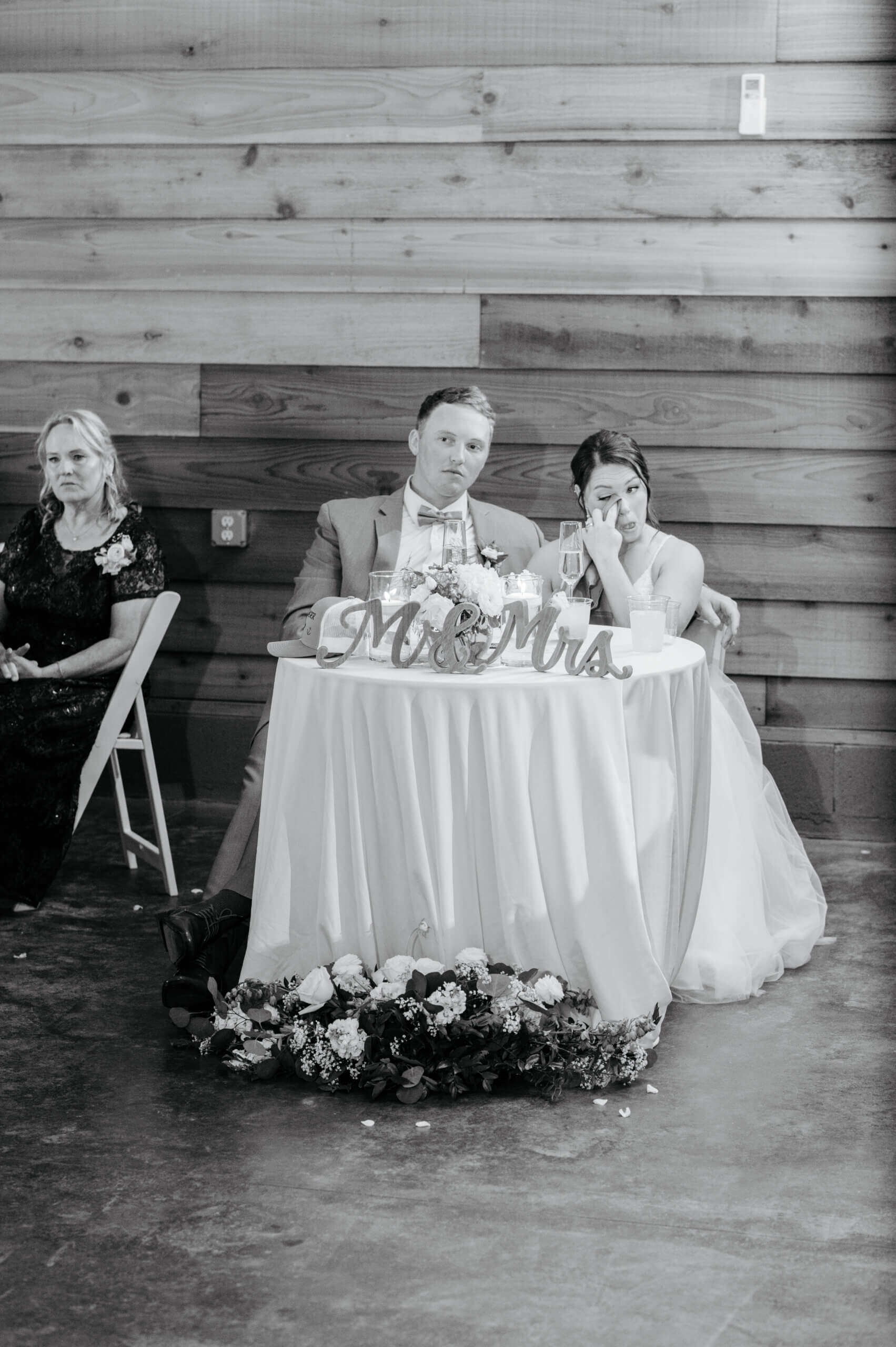 Malden Hill Spring Wedding Photography 29 black and white photo of bride wiping tears as she listens to a speech