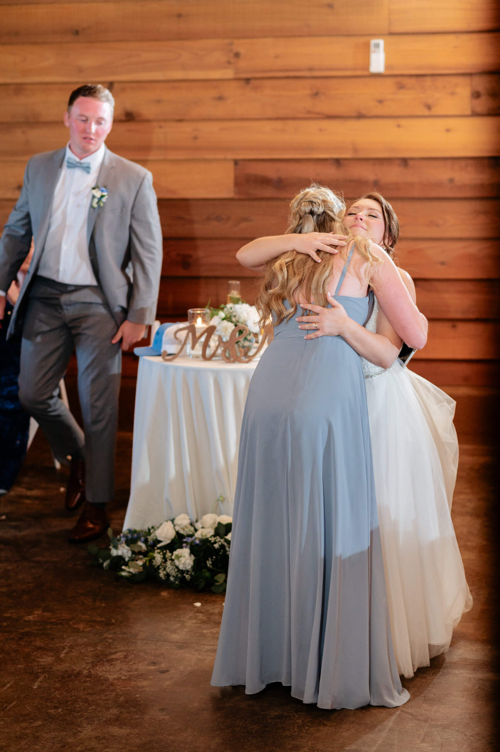 Malden Hill Spring Wedding Photography 30 bride hugging bridesmaid after speech