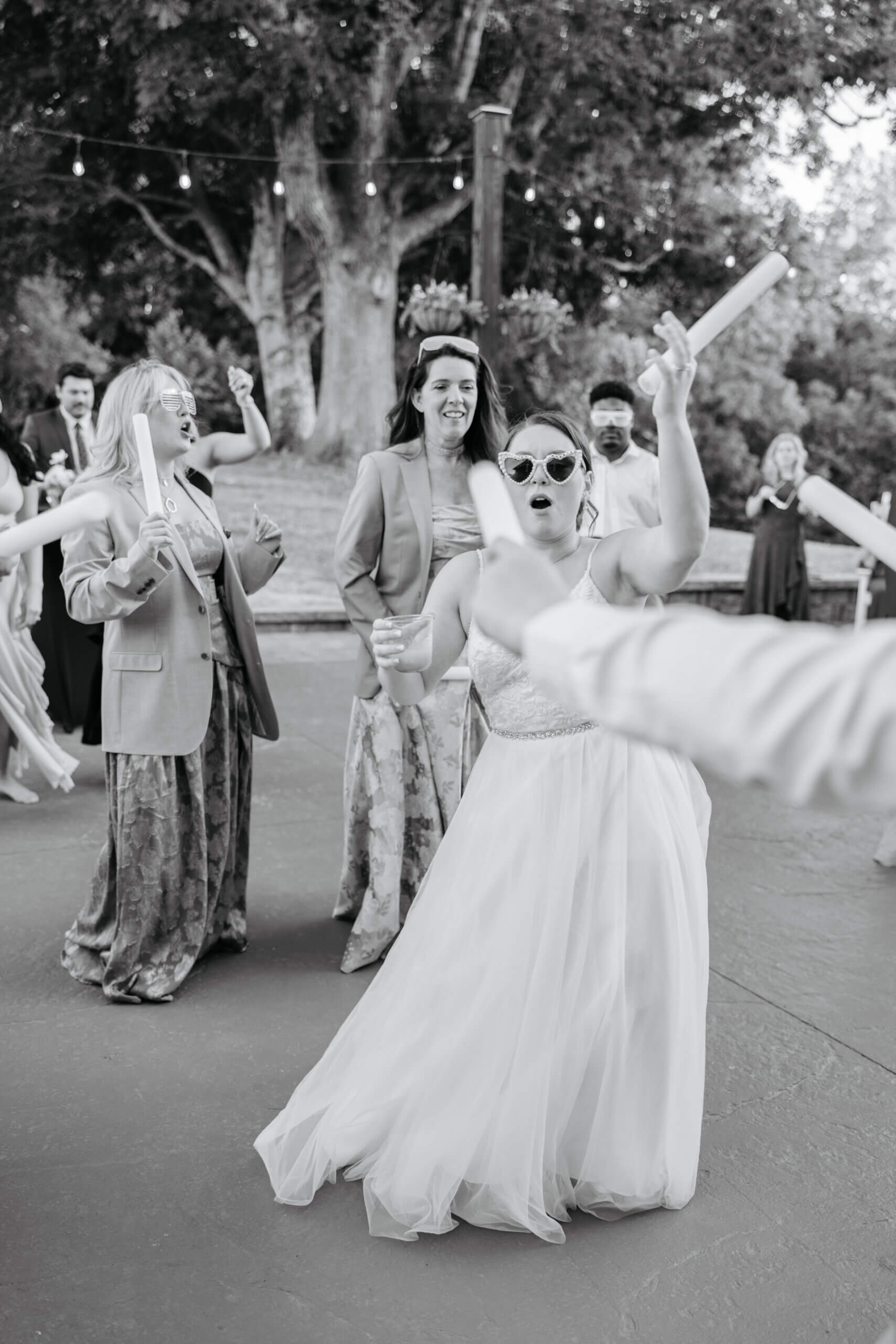 Malden Hill Spring Wedding Photography 39 black and white photo of bride wearing sunglasses and dancing